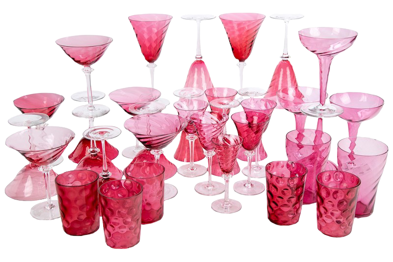 A collection of cranberry glassware including stemmed bowls, champagne glasses, water glasses and more